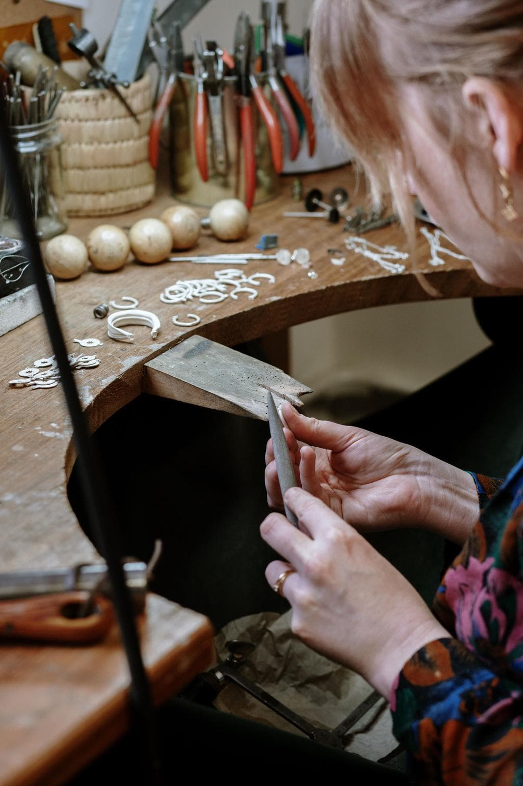 Sarah Farrow-Lane filing a piece at her Brighton workshop bench